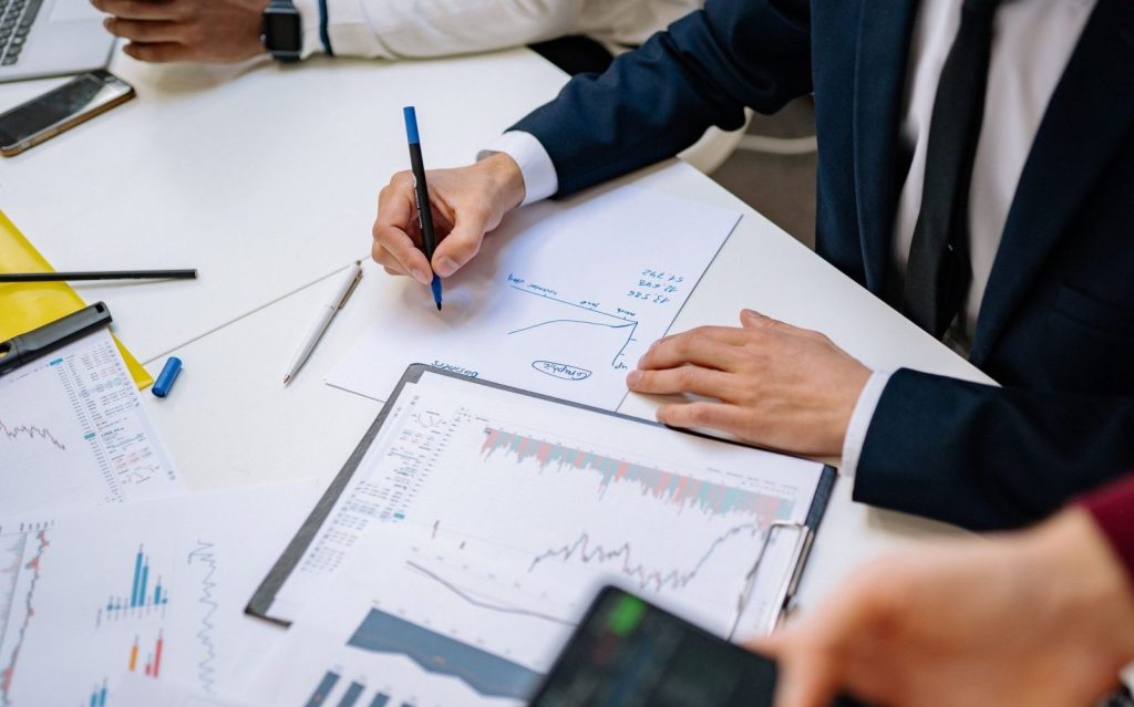 Professionals analyzing financial charts in a corporate setting.